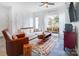 Bright living room with white walls, modern furniture, and a decorative rug creating a cozy atmosphere at 2107 W Trade St, Charlotte, NC 28216