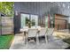 Outdoor patio featuring a dining table, string lights, and a sleek, modern design at 2107 W Trade St, Charlotte, NC 28216