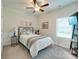 Cozy bedroom with neutral colors, a ceiling fan, and a large window at 2413 Riparian Way, Denver, NC 28037