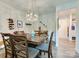 Inviting dining room with stylish lighting and wine rack, perfect for entertaining guests at 2413 Riparian Way, Denver, NC 28037