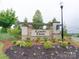 Stone entrance sign to the Canopy Creek community, enhanced by beautiful landscaping at 2413 Riparian Way, Denver, NC 28037