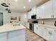 Contemporary kitchen with white cabinetry, stainless steel appliances and sleek countertops at 2413 Riparian Way, Denver, NC 28037