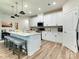Modern kitchen with white cabinets, center island, and stainless steel appliances at 2413 Riparian Way, Denver, NC 28037