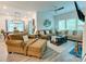 Spacious living room features comfortable seating, a ceiling fan, and large windows at 2413 Riparian Way, Denver, NC 28037