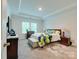 Serene main bedroom with tray ceiling, plush carpet, and a large window at 2413 Riparian Way, Denver, NC 28037