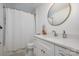 Bathroom with white vanity, round mirror, and shower/tub combo at 4114 Rutgers Ave, Charlotte, NC 28206