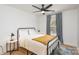 Bedroom with metal bed frame, yellow blanket, and side table at 4114 Rutgers Ave, Charlotte, NC 28206