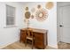 Mid-century modern home office with wood desk and wall decor at 4114 Rutgers Ave, Charlotte, NC 28206