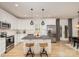 Modern kitchen featuring white cabinets, a large island, and stainless steel appliances at 4114 Rutgers Ave, Charlotte, NC 28206