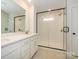 Modern bathroom with double vanity and a large walk-in shower at 10103 Mamillion Dr, Huntersville, NC 28078