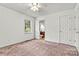 Cozy bedroom featuring plush carpet, natural light, and en-suite bathroom at 2511 Old Pond Dr, Lincolnton, NC 28092