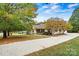 Charming single-story home with lush landscaping and a long private driveway at 2511 Old Pond Dr, Lincolnton, NC 28092