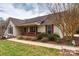 Charming single-story home featuring a welcoming front porch and well-maintained landscaping, set under a cloudy sky at 2511 Old Pond Dr, Lincolnton, NC 28092