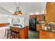 Well-equipped kitchen featuring dark wood cabinetry, a central island with seating, and modern appliances at 2511 Old Pond Dr, Lincolnton, NC 28092