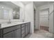 Bathroom with double vanity, gray cabinets, and a walk-in shower at 318 Bezelle Ave, York, SC 29745