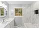 Updated bathroom with white vanity and marble tile at 3327 Deerwood Dr, Gastonia, NC 28054
