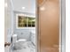 Updated bathroom with marble flooring and a large window at 3327 Deerwood Dr, Gastonia, NC 28054