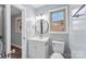 Clean bathroom with white vanity and a round mirror at 3327 Deerwood Dr, Gastonia, NC 28054
