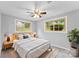 Cozy bedroom with two windows, ceiling fan, and mid-century modern furniture at 3327 Deerwood Dr, Gastonia, NC 28054