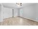 Well-lit bedroom with door to exterior and ceiling fan at 3327 Deerwood Dr, Gastonia, NC 28054