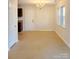 Formal dining area with chandelier, neutral walls, and carpet flooring at 353 Skyland Ave, Charlotte, NC 28205