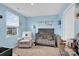 Cozy Bedroom with crib, chair, and blue walls, ready for a new Gathering at 1197 Tangle Ridge Se Dr, Concord, NC 28025