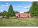 Entrance to the community featuring a brick sign, landscaping, and blue skies at 1197 Tangle Ridge Se Dr, Concord, NC 28025