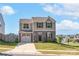 Two-story house with a two-car garage, an American flag, a well-kept lawn, and landscaping at 1197 Tangle Ridge Se Dr, Concord, NC 28025