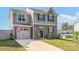 Two-story house with a two-car garage, an American flag, a well-kept lawn and attractive landscaping at 1197 Tangle Ridge Se Dr, Concord, NC 28025