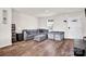 Living room with sectional sofa and hardwood floors at 1197 Tangle Ridge Se Dr, Concord, NC 28025