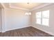 Spacious dining room featuring hardwood floors and a large window at 166 Wylie Trl # 25, Statesville, NC 28677