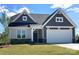 Gray-sided house with white garage door and landscaping at 166 Wylie Trl # 25, Statesville, NC 28677