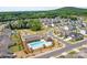 A vibrant community pool with red umbrellas, lounge chairs, and well-maintained landscaping at 1957 Tablerock Dr, York, SC 29745