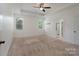 Bright main bedroom featuring carpet, tray ceiling, and an ensuite bathroom at 1957 Tablerock Dr, York, SC 29745