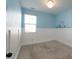 Light-filled bedroom with carpet, white wainscoting, and a blue accent wall at 1957 Tablerock Dr, York, SC 29745