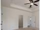 Neutral-toned bedroom features a tray ceiling, carpeted floor, and an open doorway at 1957 Tablerock Dr, York, SC 29745