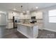 Spacious kitchen with white cabinets, stainless steel appliances, and a granite island at 1957 Tablerock Dr, York, SC 29745