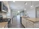 Open-concept kitchen flowing into the living area, featuring a granite island and modern appliances at 1957 Tablerock Dr, York, SC 29745