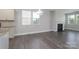 Open-concept living room with fireplace, modern light fixture, and wood-look floors at 1957 Tablerock Dr, York, SC 29745