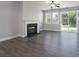 Bright living room featuring a fireplace, windows, and sliding glass door to the backyard at 1957 Tablerock Dr, York, SC 29745