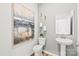 Small powder room with pedestal sink and art at 327 Bezelle Ave, York, SC 29745