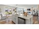 Kitchen island with sink, dishwasher, and view into living room at 327 Bezelle Ave, York, SC 29745