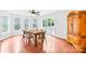 Sunlit breakfast area with wood floors, table set, and sliding door access to the patio at 141 Red Brook Ln, Mooresville, NC 28117