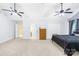 Bright main bedroom featuring vaulted ceilings, ceiling fans, and neutral carpeting at 141 Red Brook Ln, Mooresville, NC 28117
