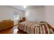 Bright bedroom with hardwood floors and striped bedding at 1499 Angela Ct, Lincolnton, NC 28092