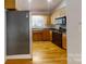 Kitchen with wood cabinets, black appliances, and hardwood floors at 1499 Angela Ct, Lincolnton, NC 28092