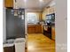 Galley kitchen with wood cabinets, black appliances, and hardwood floors at 1499 Angela Ct, Lincolnton, NC 28092