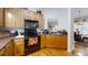 Kitchen with wood cabinets, black appliances, and hardwood floors at 1499 Angela Ct, Lincolnton, NC 28092