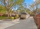 Landscaped backyard featuring a patio area and driveway access at 316 W Kingston Ave, Charlotte, NC 28203