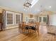 Bright dining room with hardwood floors and charming chandelier at 316 W Kingston Ave, Charlotte, NC 28203